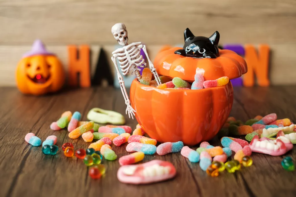 happy-halloween-day-with-ghost-candies-pumpkin-bowl-jack-o-lantern-and-decorative-selective-focus-trick-or-threat-hello-october-fall-autumn-festive-party-and-holiday-concept