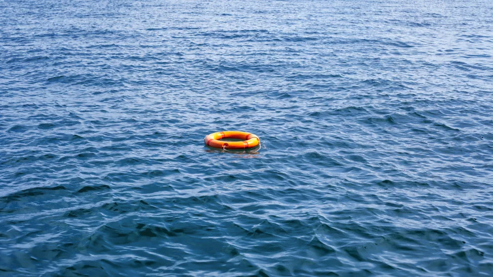 orange-life-buoy-floating-in-sea-red-lifebuoy-float-on-ocean-waves