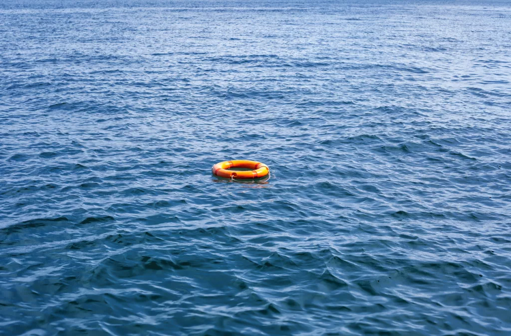 orange-life-buoy-floating-in-sea-red-lifebuoy-float-on-ocean-waves