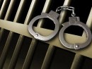 arrest-5-hancuffs-on-right-with-cell-bars