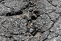 cracked-and-crumbling-asphalt-road-surface-image-shot-2008-exact-date-unknown