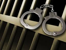 arrest-5-hancuffs-on-right-with-cell-bars-2