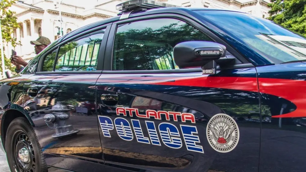 Atlanta police car and officer on cellphone Atlanta^ Ga USA - 06 07 20