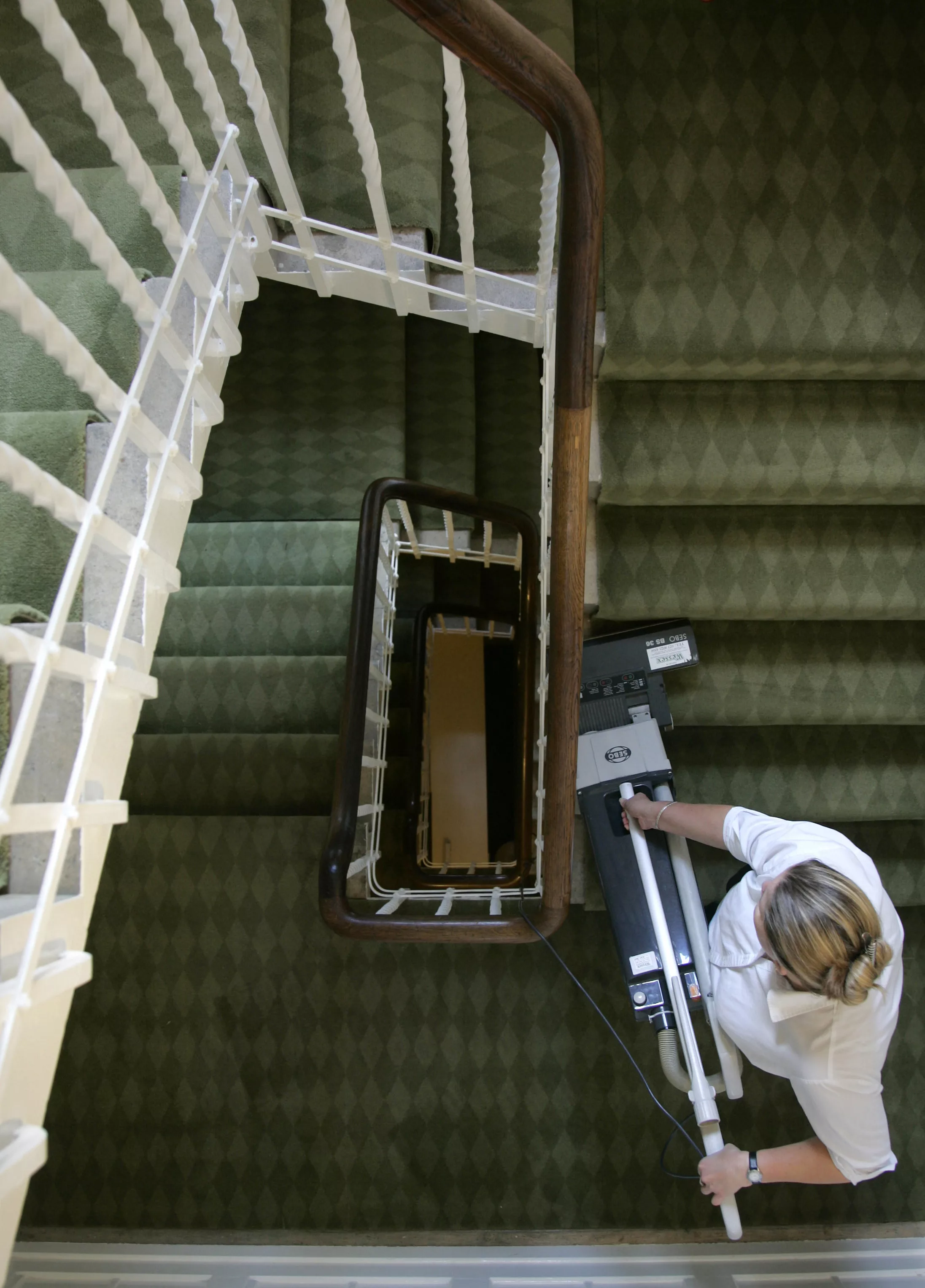 housekeeper-sheldon-vacuum-cleans-the-stairs-at-palace-house-at-beaulieu-the-home-of-lord-montagu-in-southern-england
