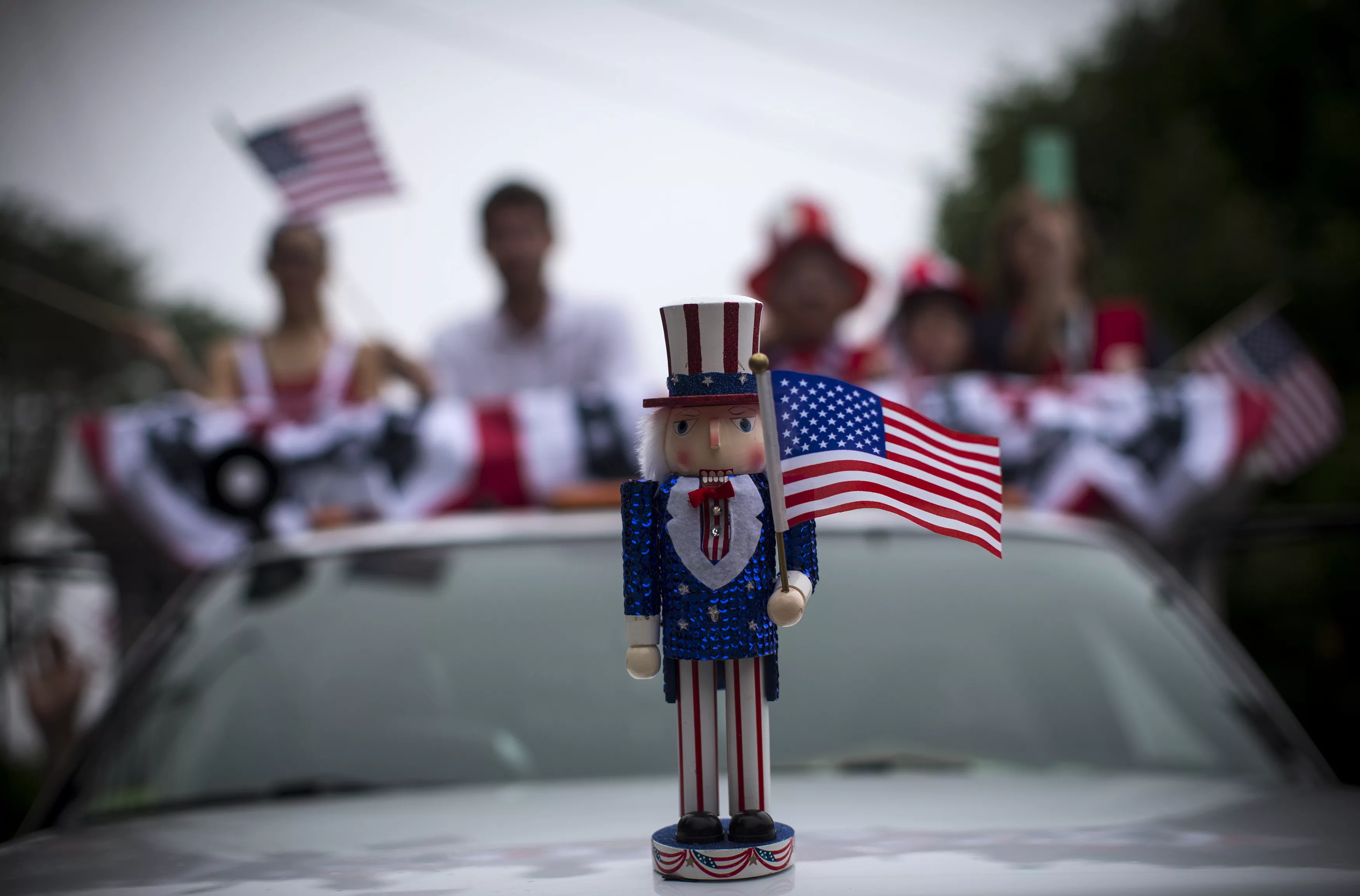 an-uncle-sam-figure-sits-on-the-hood-of-a-car-in-a-july-fourth-parade-in-the-village-of-barnstable-massachusetts