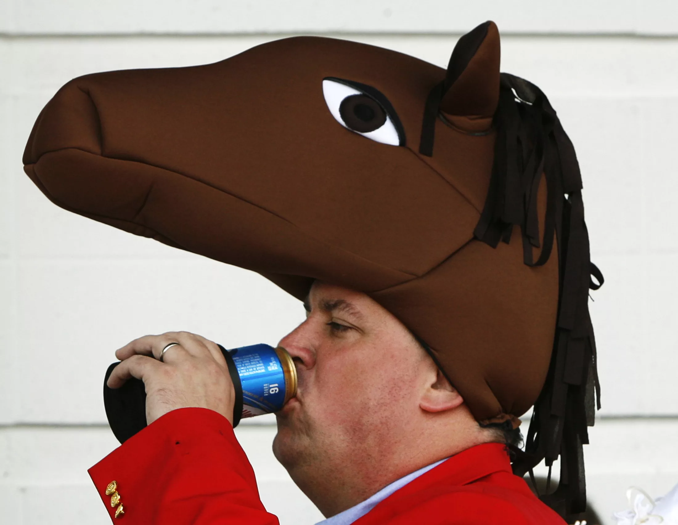 a-race-fan-wearing-a-horse-head-hat-pauses-for-refreshment-ahead-of-the-135th-running-of-the-kentucky-derby-at-churchill-downs-in-louisville