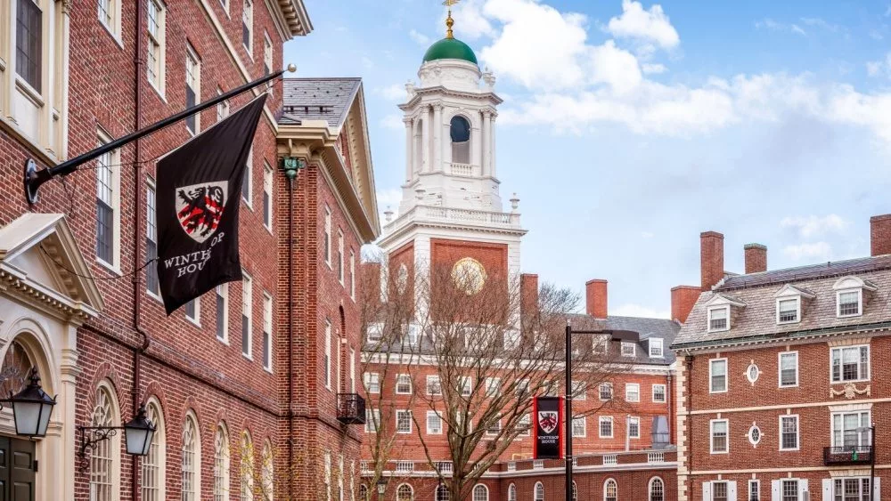 View of the architecture of the famous Harvard University in Cambridge^ Massachusetts^ USA showcasing it brick buildings with some students and locals passing by . Cambridge^ MA^ USA - March 15^ 2024