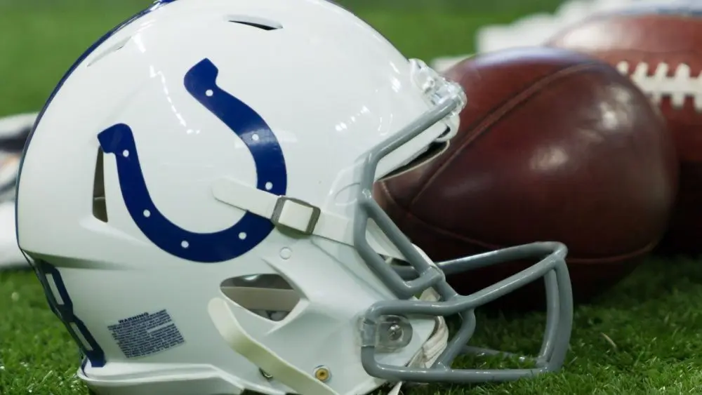 Indianapolis Colts helmet shown on field next to football; Colts host the Oakland Raiders on 9/29/19 at Lucas Oil Stadium in Indianapolis IN-USA