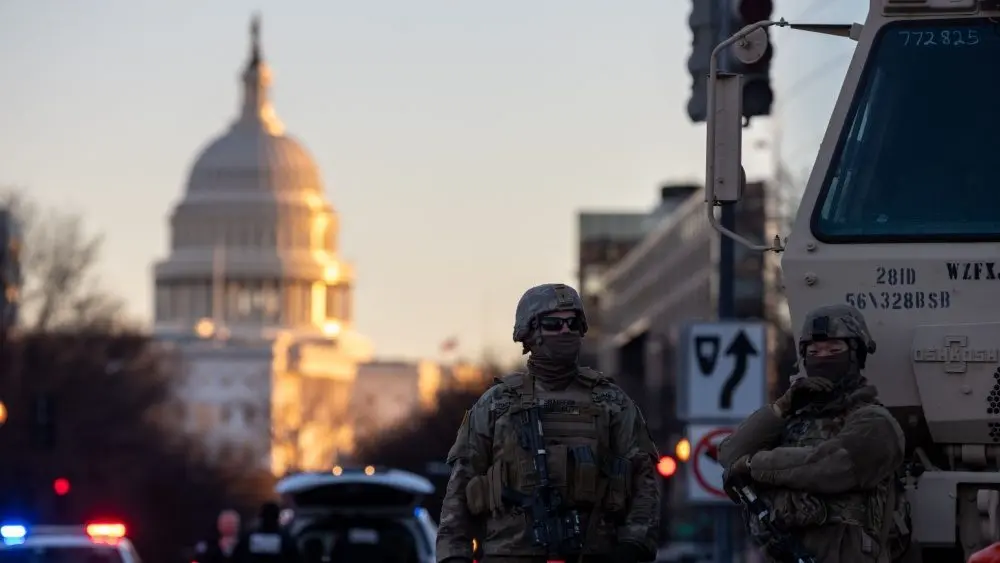 Members of the National Guard patrol the area surrounding the outskirts of the Capitol Building on January 19^ 2021^ in Washington D.C.