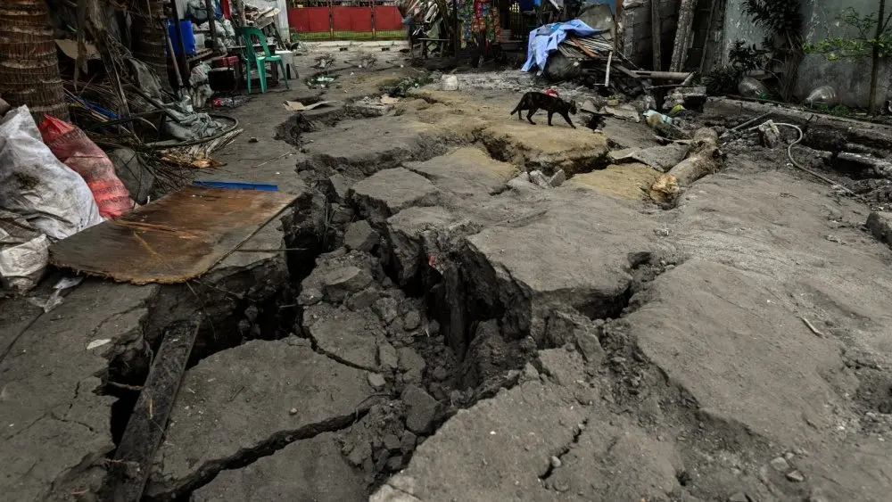 An earthquake-cracked street is seen a day after a magnitude 7.2 earthquake struck La Guaira^ causing widespread damage and disrupting transportation infrastructure. La Guaira^ Venezuela - June 25^ 2026