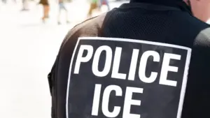Ice police agent - Officer of Immigration and Customs Enforcement. Close up of POLICE ICE on back of stab proof vest worn by DHS Department of Homeland Security police officer at the scene of incident