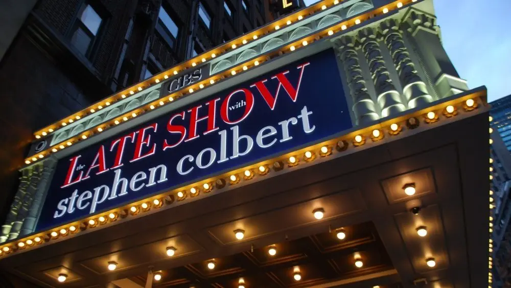 Manhattan NYC buildings in Times Square^ Broadway street avenue road^ signs for Stephen Colbert Late Show- Marquee / Theatre at Night