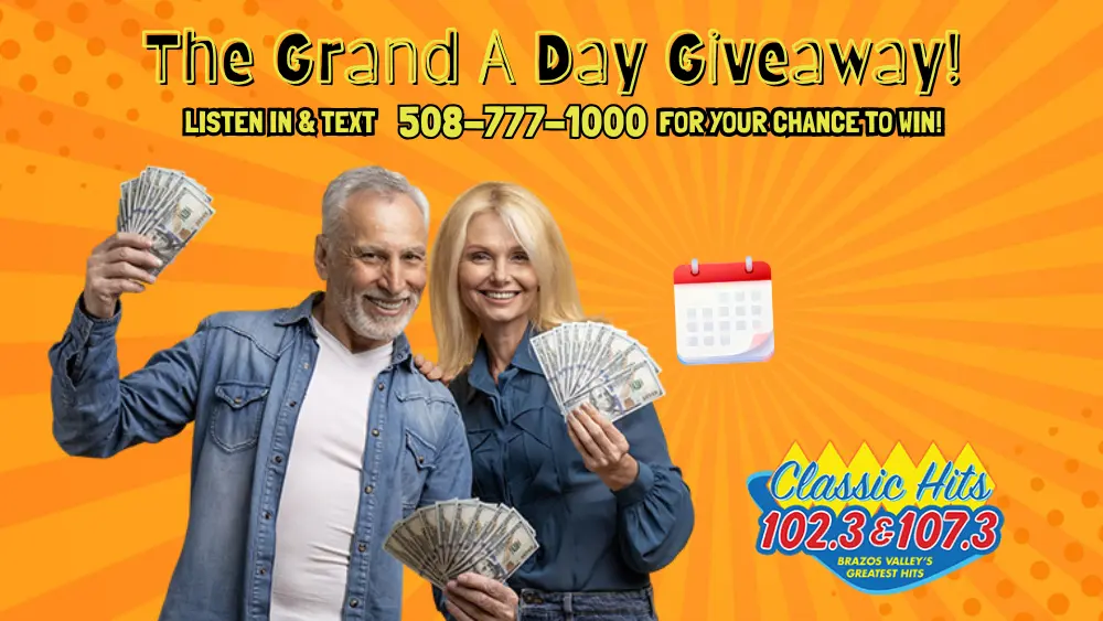 A woman and man excitedly flash the money they won in the Grand A Day Giveaway contest!