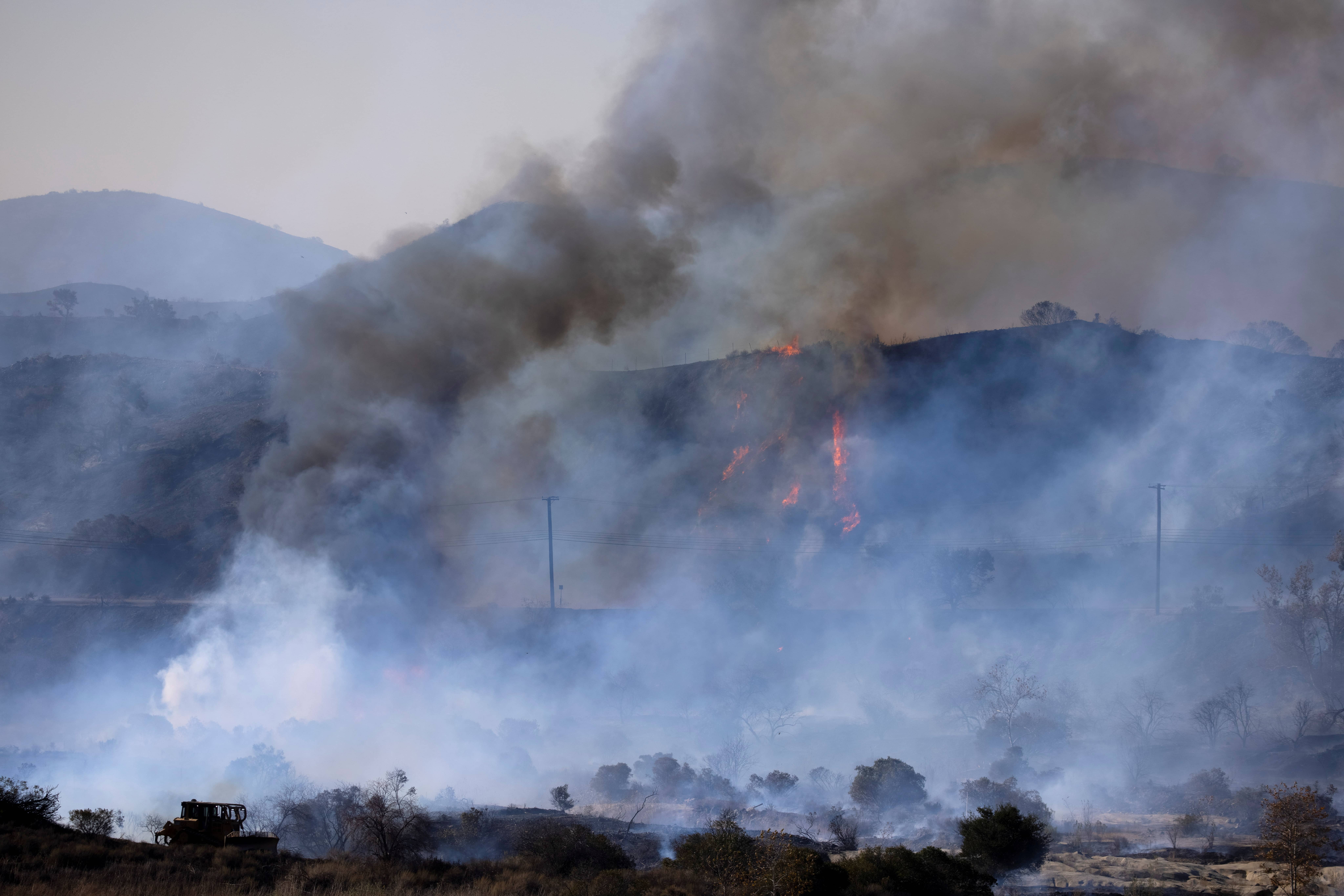 file-photo-a-firefighting-bulldozer-battles-the-bond-fire-wildfire-near-lake-irvine-in-orange-county-california