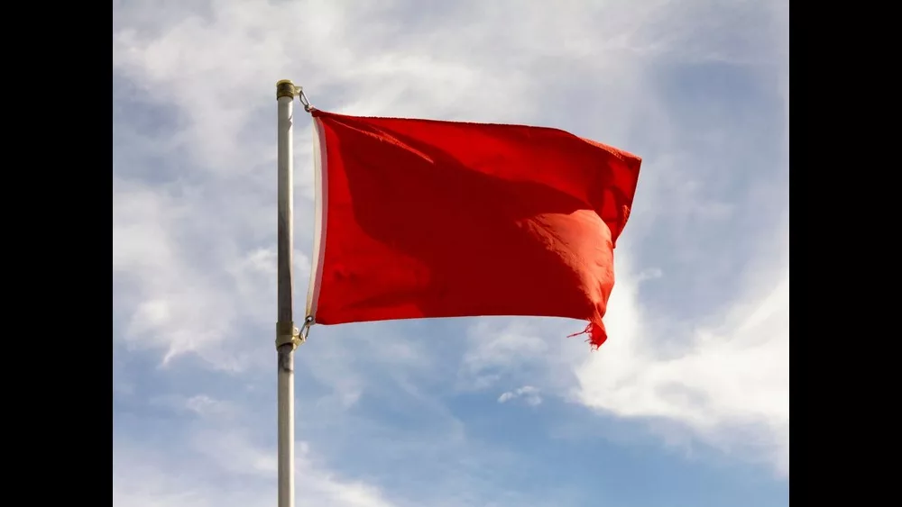 low-angle-view-of-red-flag-against-sky-royalty-free-image-1634139130
