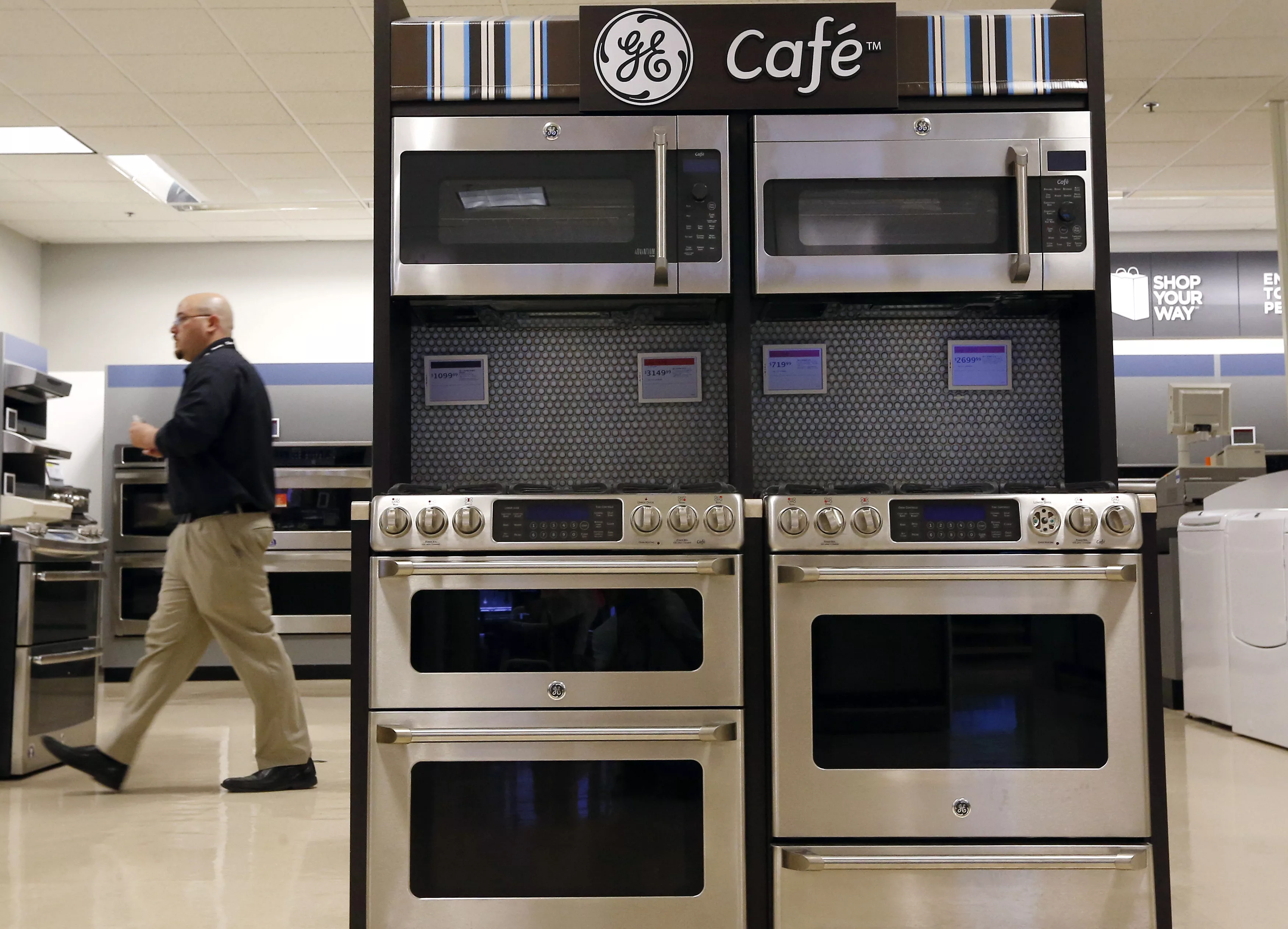 sears-employee-walks-past-a-display-of-general-electric-appliances-in-schaumburg