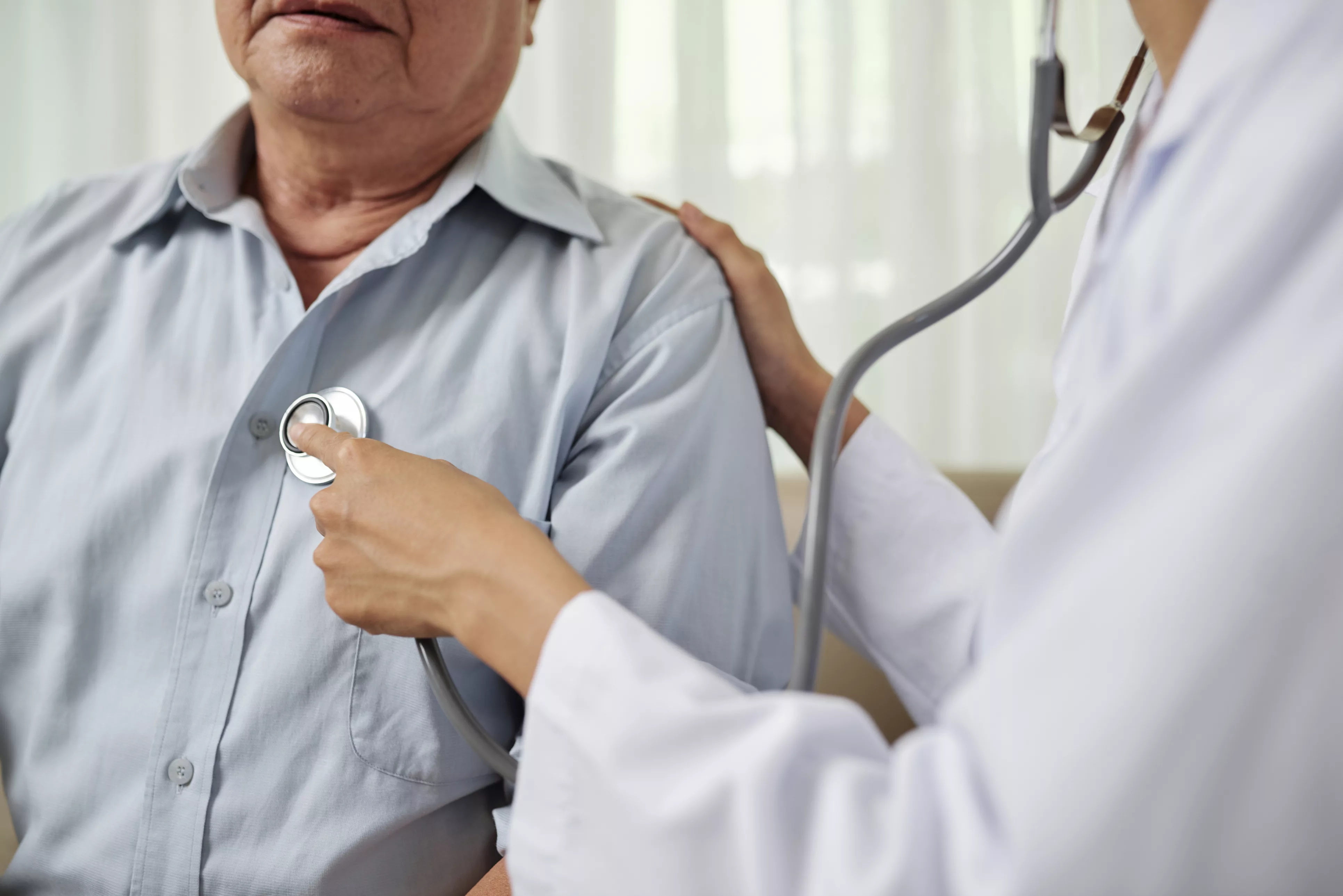 doctor-listening-to-senior-breathing-man