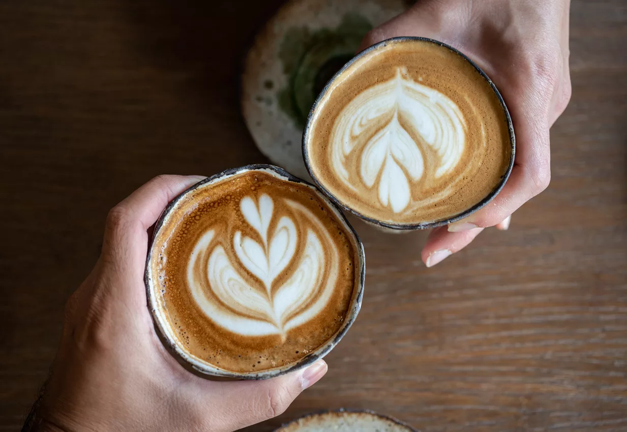 high-angle-view-of-friends-meeting-in-cafe-with-a-cup-of-hot-latte-coffee