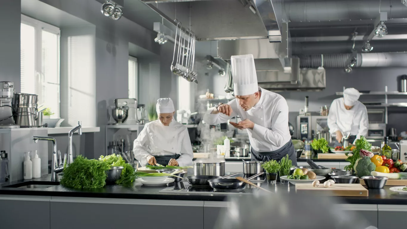 famous-chef-works-in-a-big-restaurant-kitchen-with-his-help-kitchen-is-full-of-food-vegetables-and-boiling-dishes-he-is-trying-taste