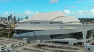 Aerial shot of LoanDepot Park with skyscrapers and office buildings in the city skyline^ lush green palm trees and cars on the street in Miami Florida USA Miami Florida USA - 11 -12-2024