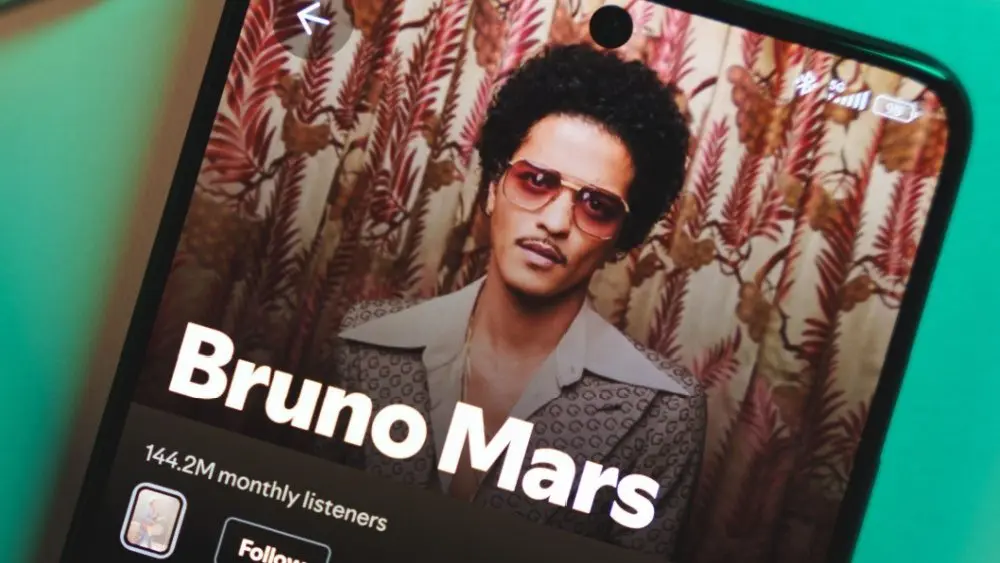 A smartphone displaying Bruno Mars's artist profile on Spotify. January 5^ 2025