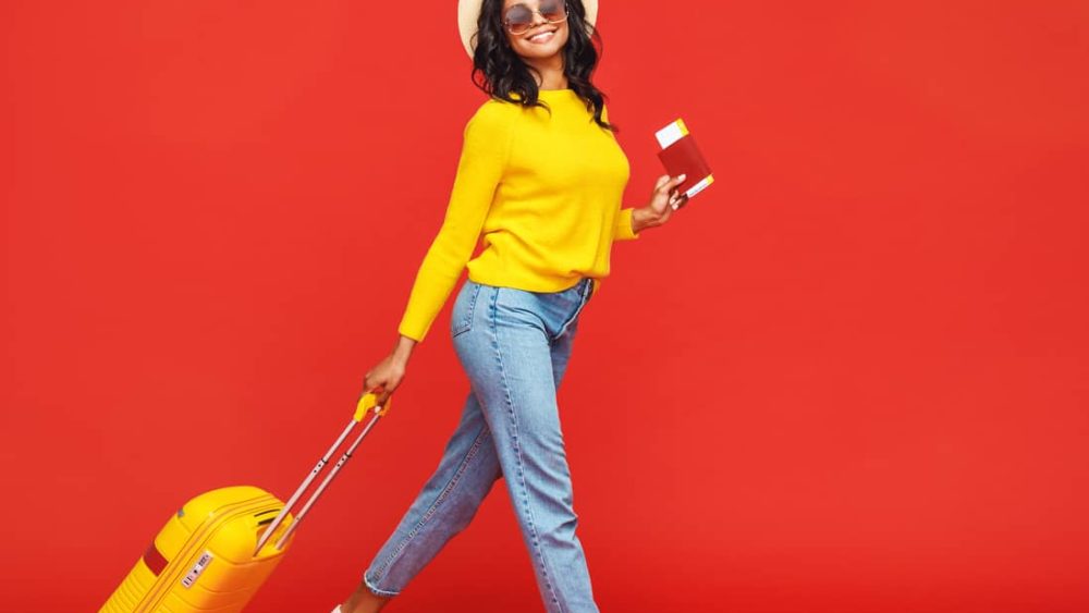 ethnic-traveler-walking-with-suitcase
