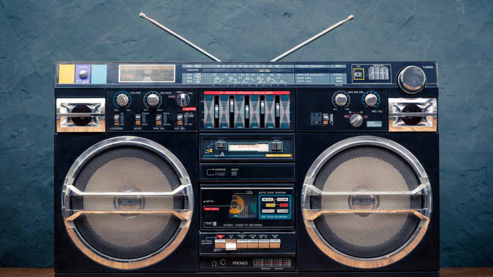retro-boombox-ghetto-blaster-outdated-portable-black-radio-receiver-with-cassette-recorder-from-80s-front-concrete-wall-background-rap-hip-hop-rb-music-concept-vintage-old-style-filtered-phot