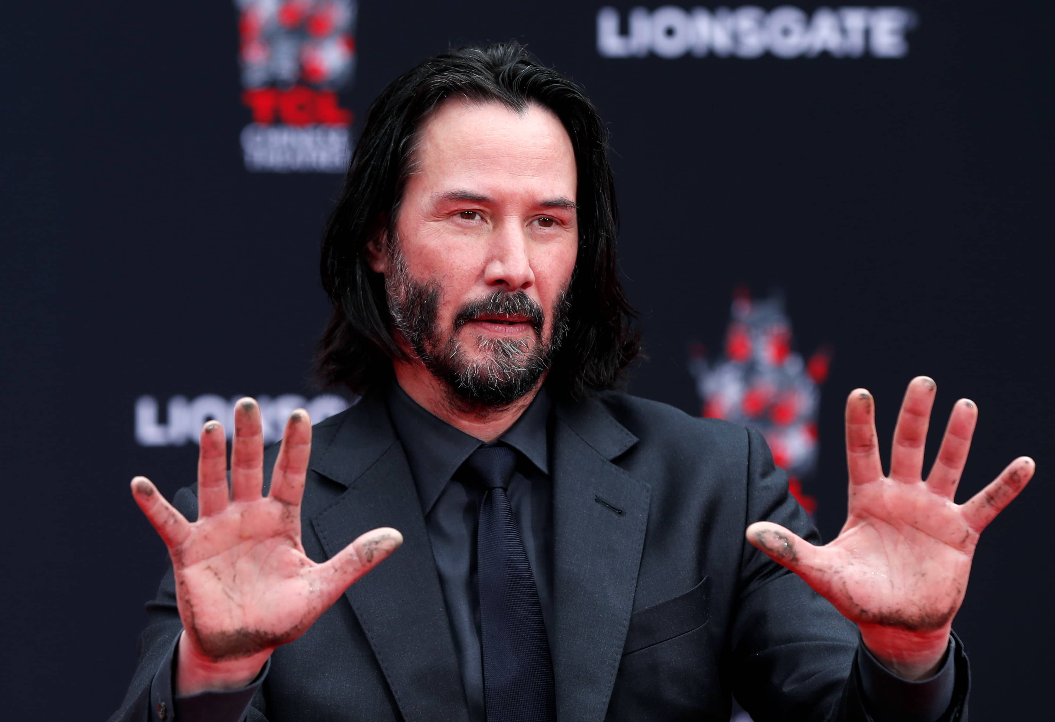 actor-keanu-reeves-puts-his-hand-and-footprints-in-cement-in-los-angeles