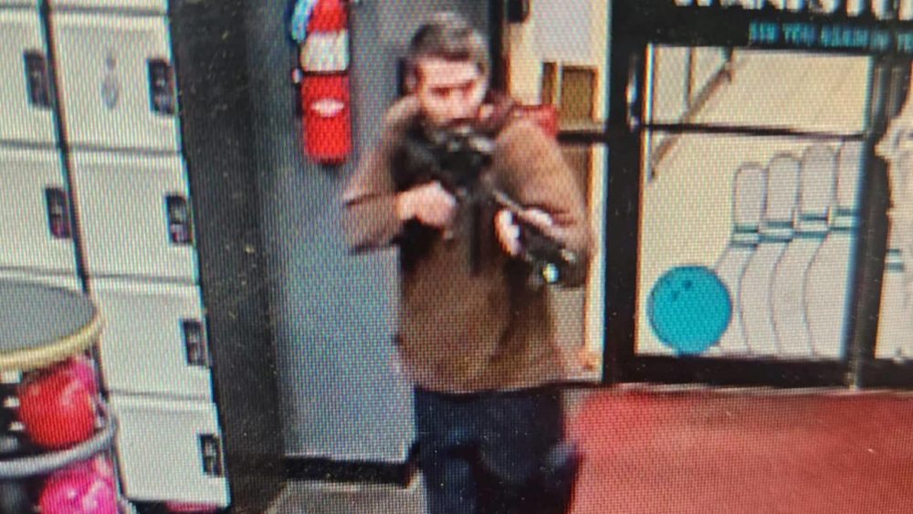 a-still-image-from-surveillance-camera-video-shows-a-man-with-a-gun-in-lewiston