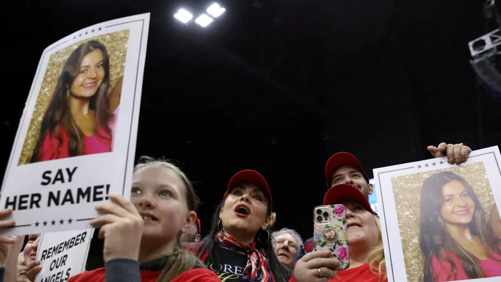 people-hold-campaign-signs-with-a-photo-of-laken-riley-during-the-rally-in-rome-georgia