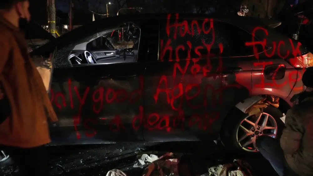 people-look-through-discarded-items-from-a-vandalized-car-in-minneapolis