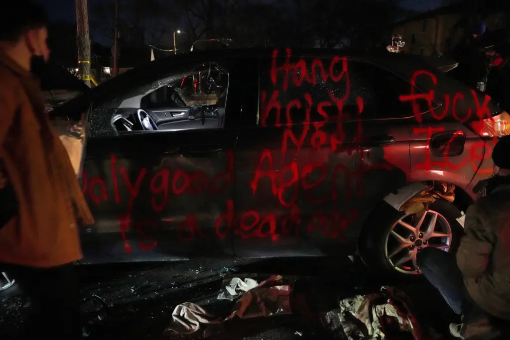 people-look-through-discarded-items-from-a-vandalized-car-in-minneapolis