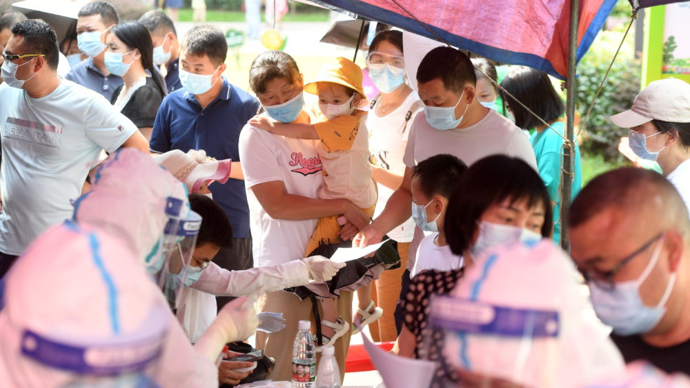 medical-workers-attend-to-residents-lining-up-during-a-citywide-nucleic-acid-testing-following-new-covid-19-cases-in-wuhan