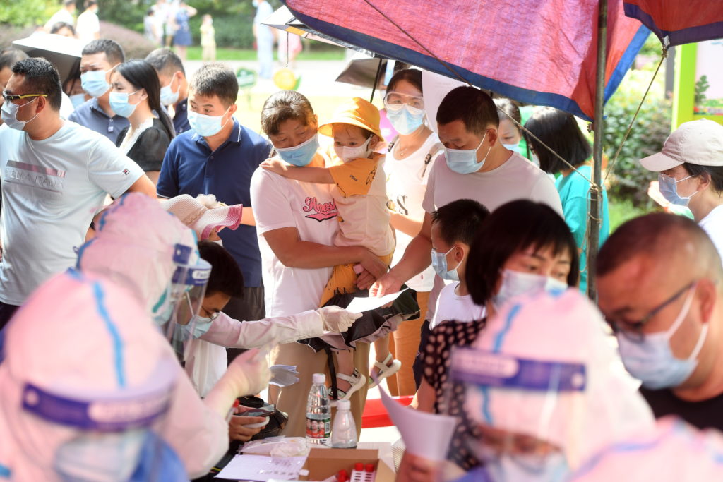 medical-workers-attend-to-residents-lining-up-during-a-citywide-nucleic-acid-testing-following-new-covid-19-cases-in-wuhan