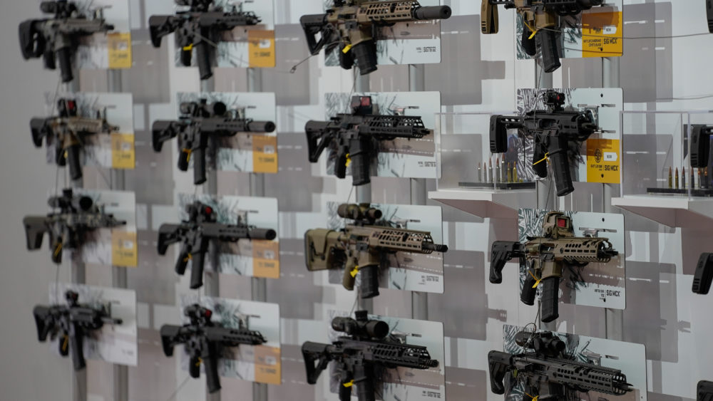 a-wall-of-semi-automatic-rifles-hang-on-display-inside-the-indiana-convention-center-as-part-of-the-annual-national-rifle-association-nra-convention-in-indianapolis-indiana