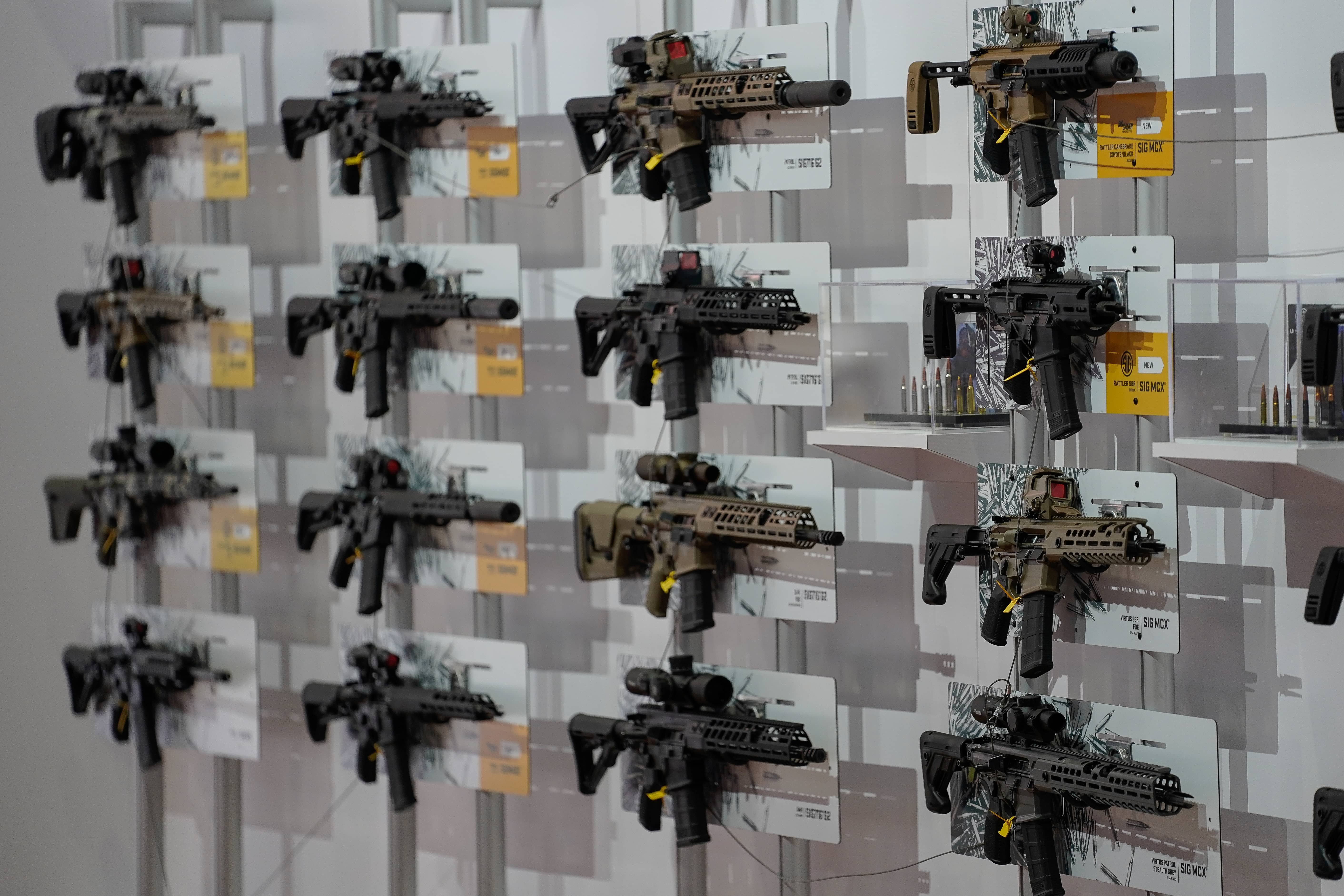 a-wall-of-semi-automatic-rifles-hang-on-display-inside-the-indiana-convention-center-as-part-of-the-annual-national-rifle-association-nra-convention-in-indianapolis-indiana
