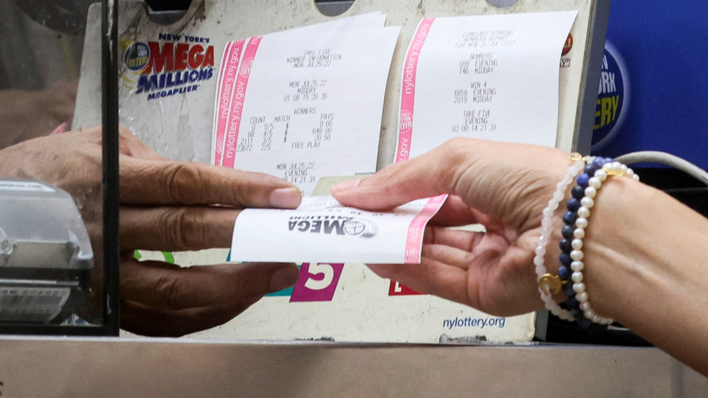 file-photo-a-woman-buys-a-ticket-for-the-mega-millions-lottery-drawing-at-a-news-stand-in-new-york