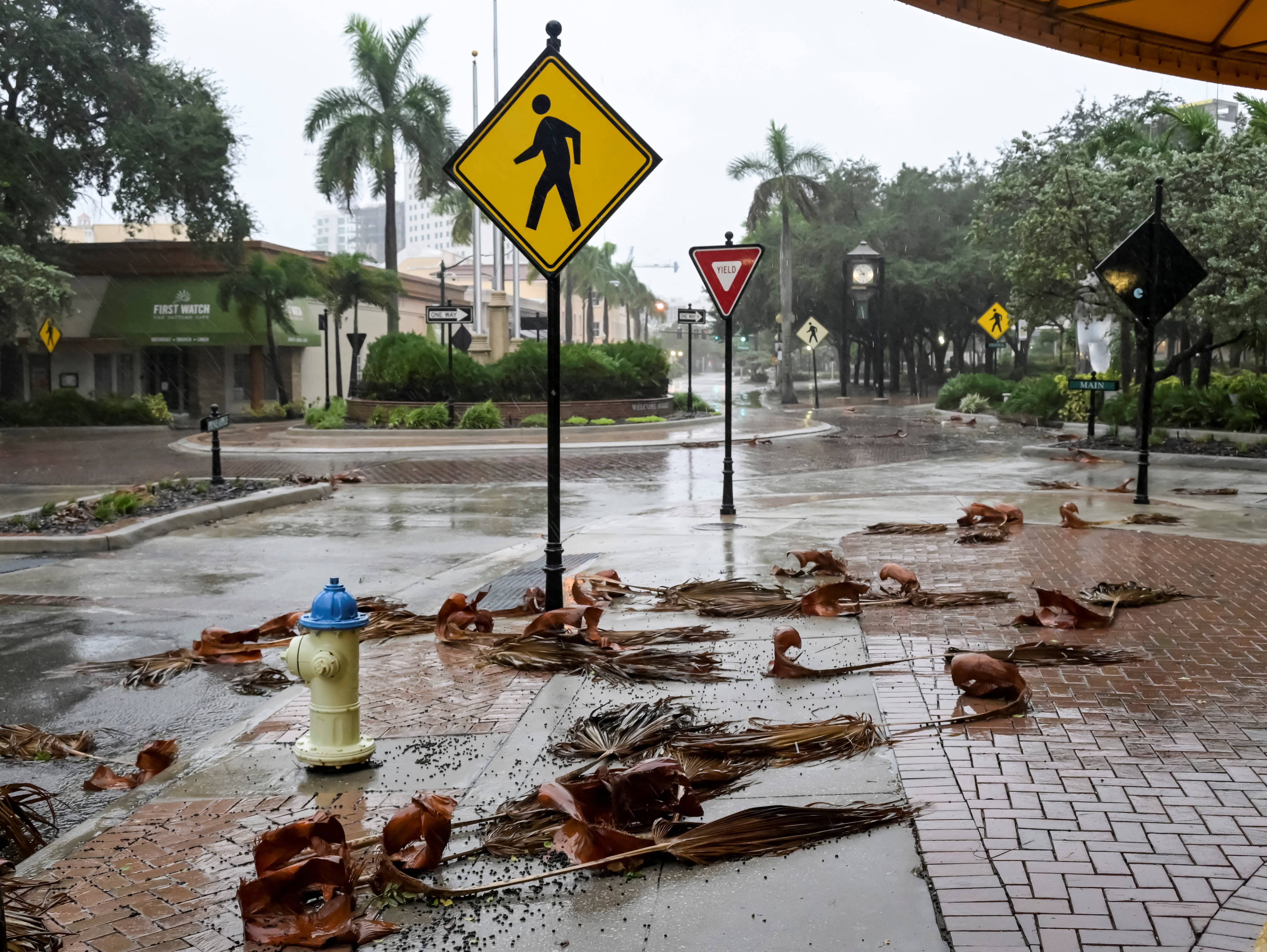 downed-palm-fronds-collect-on-an-empty-downtown-intersection-as-hurricane-ian-approaches-floridas-gulf-coast
