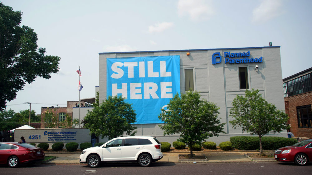 file-photo-a-banner-stating-still-here-hangs-on-the-side-of-the-planned-parenthood-building-after-a-judge-granted-a-temporary-restraining-order-on-the-closing-of-missouris-sole-remaining-planned-p