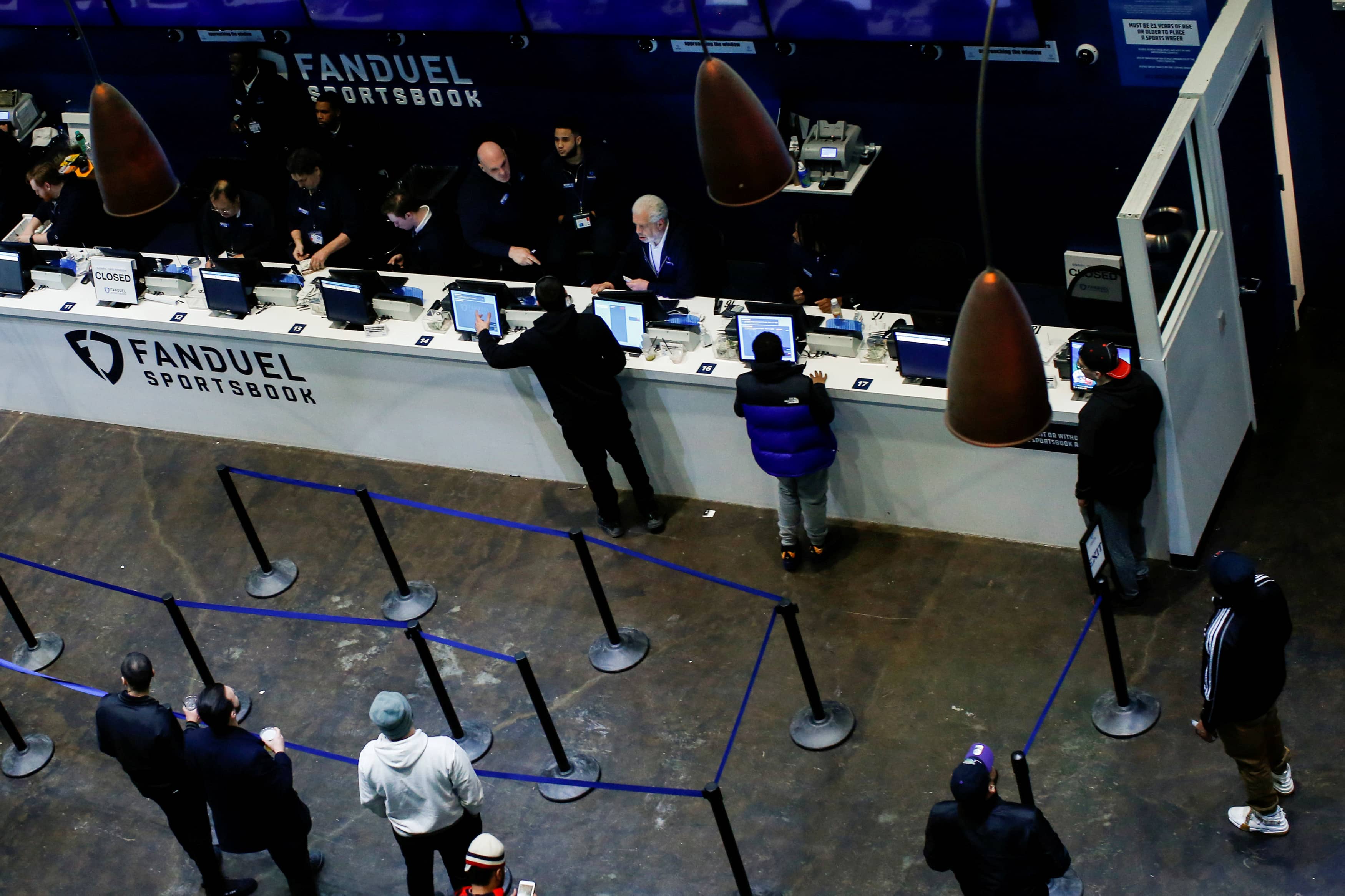 file-photo-people-make-their-bets-at-the-fanduel-sportsbook-during-the-super-bowl-liii-in-east-rutherford-new-jersey