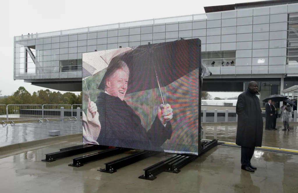 video-board-showing-clinton-with-library-in-background-during-dedication-ceremony-in-little-rock