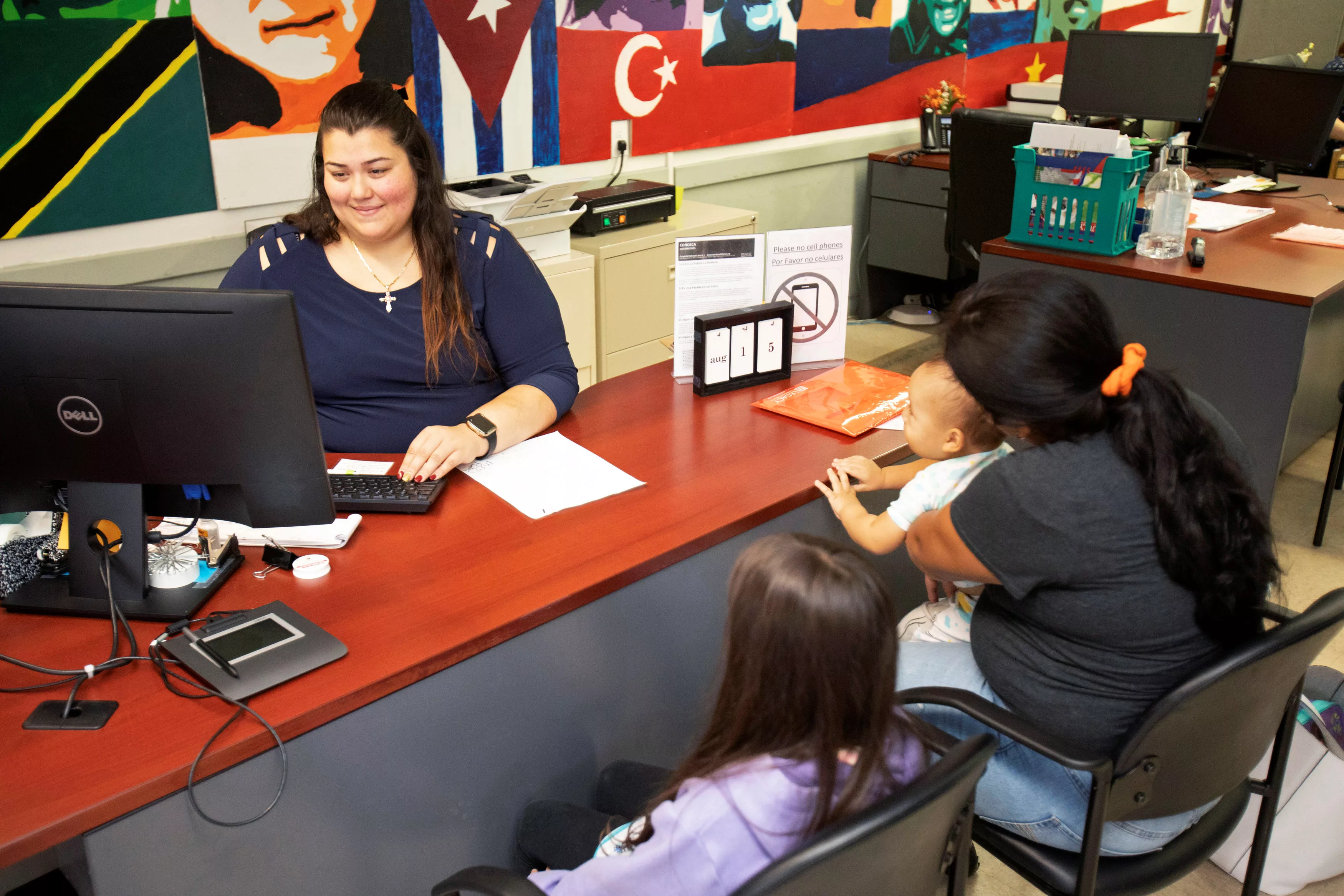staff-worker-maricela-delcid-works-with-clients-seeking-assistance-for-their-medicaid-application-and-access-to-echos-food-pantry-at-the-echos-center-in-houston