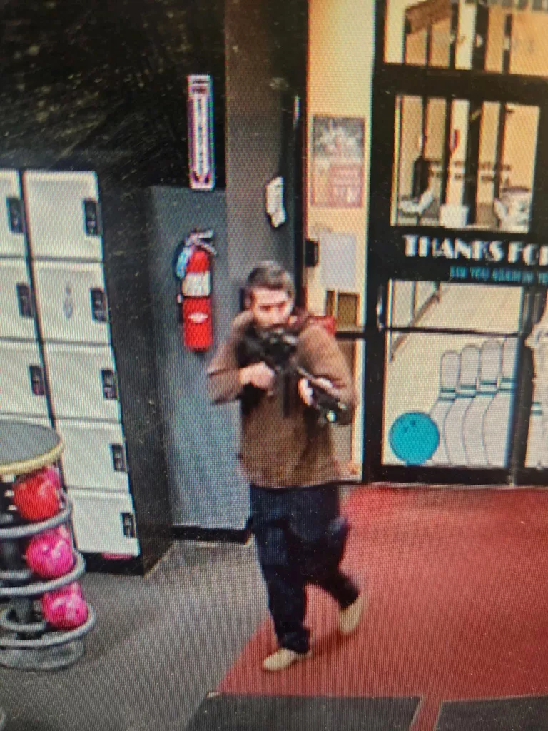 a-still-image-from-surveillance-camera-video-shows-a-man-with-a-gun-in-lewiston