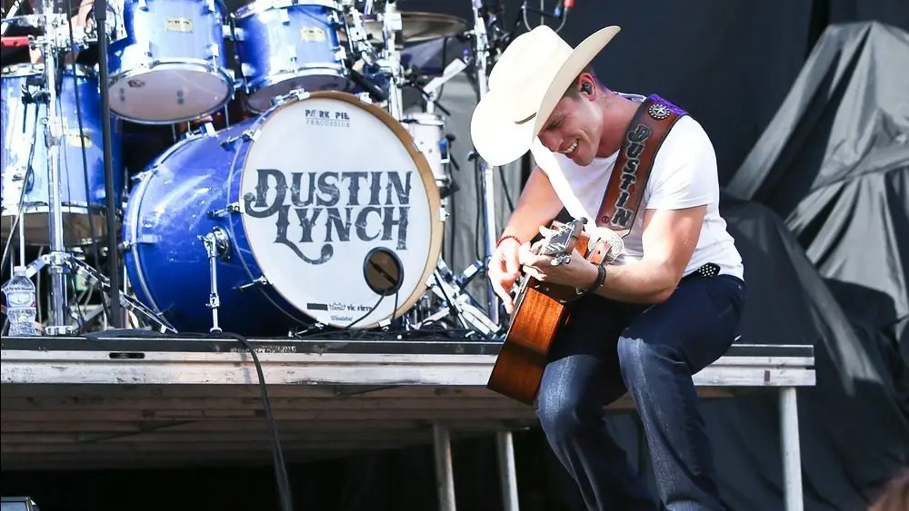 Dustin Lynch performs during the 'Kick The Dust Up' Tour at Vanderbilt Stadium on July 11^ 2015 in Nashville^ Tennessee.