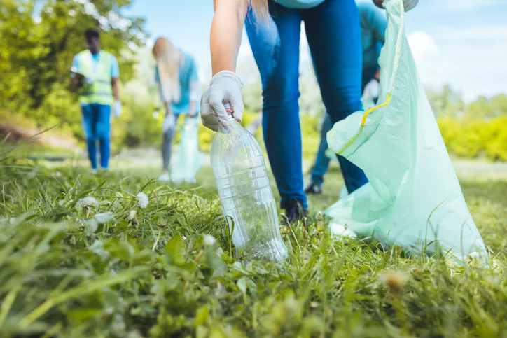 an-unrecognizable-woman-holds-a-plastic-garbage-bottle