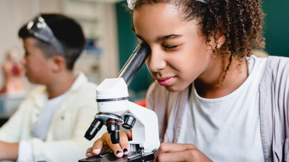 african-american-schoolgirl-pupil-student-using-working-with-microscope-at-biology-chemistry-lesson-class-at-school-lab-science-lesson-concept