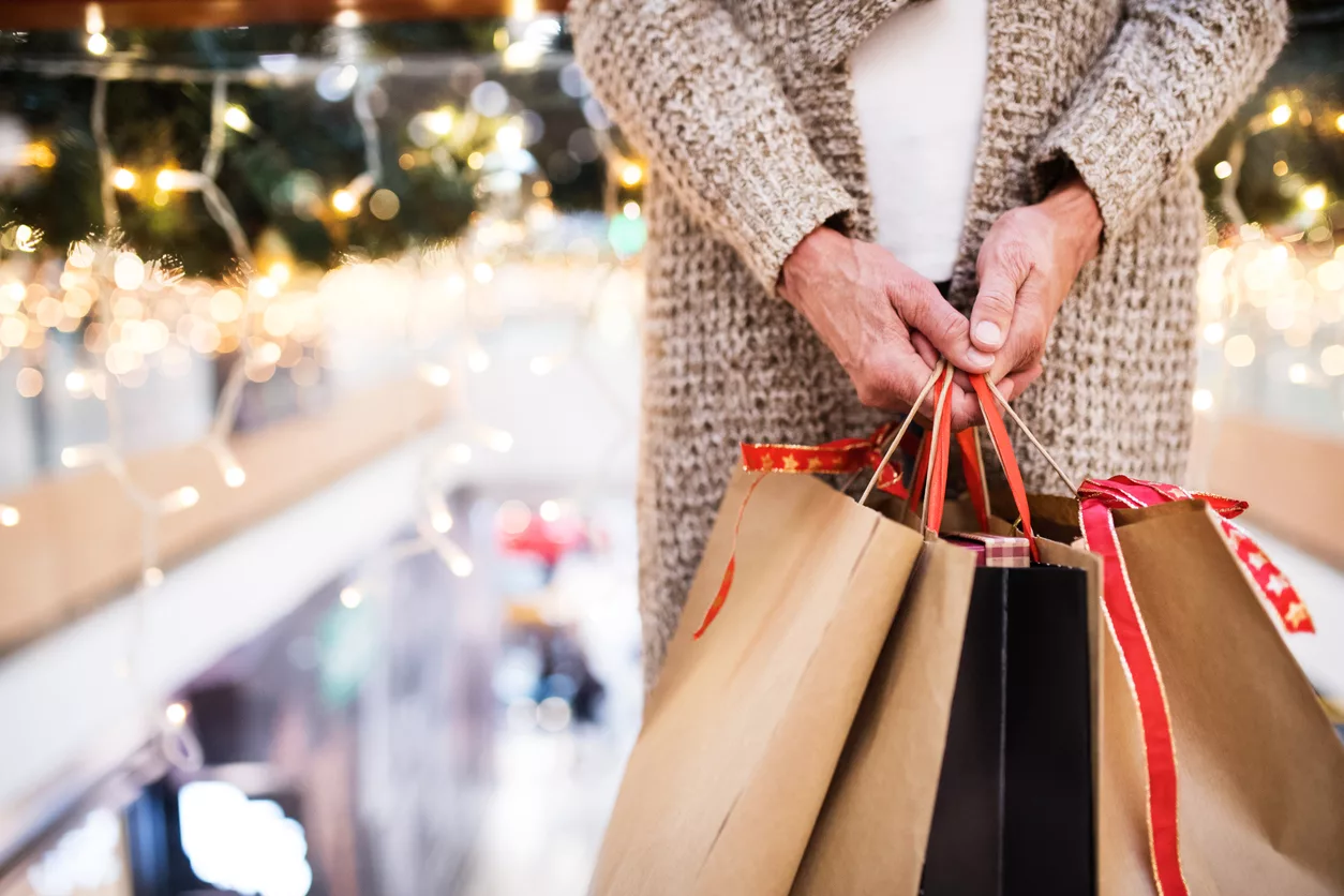 senior-woman-with-bags-doing-christmas-shopping