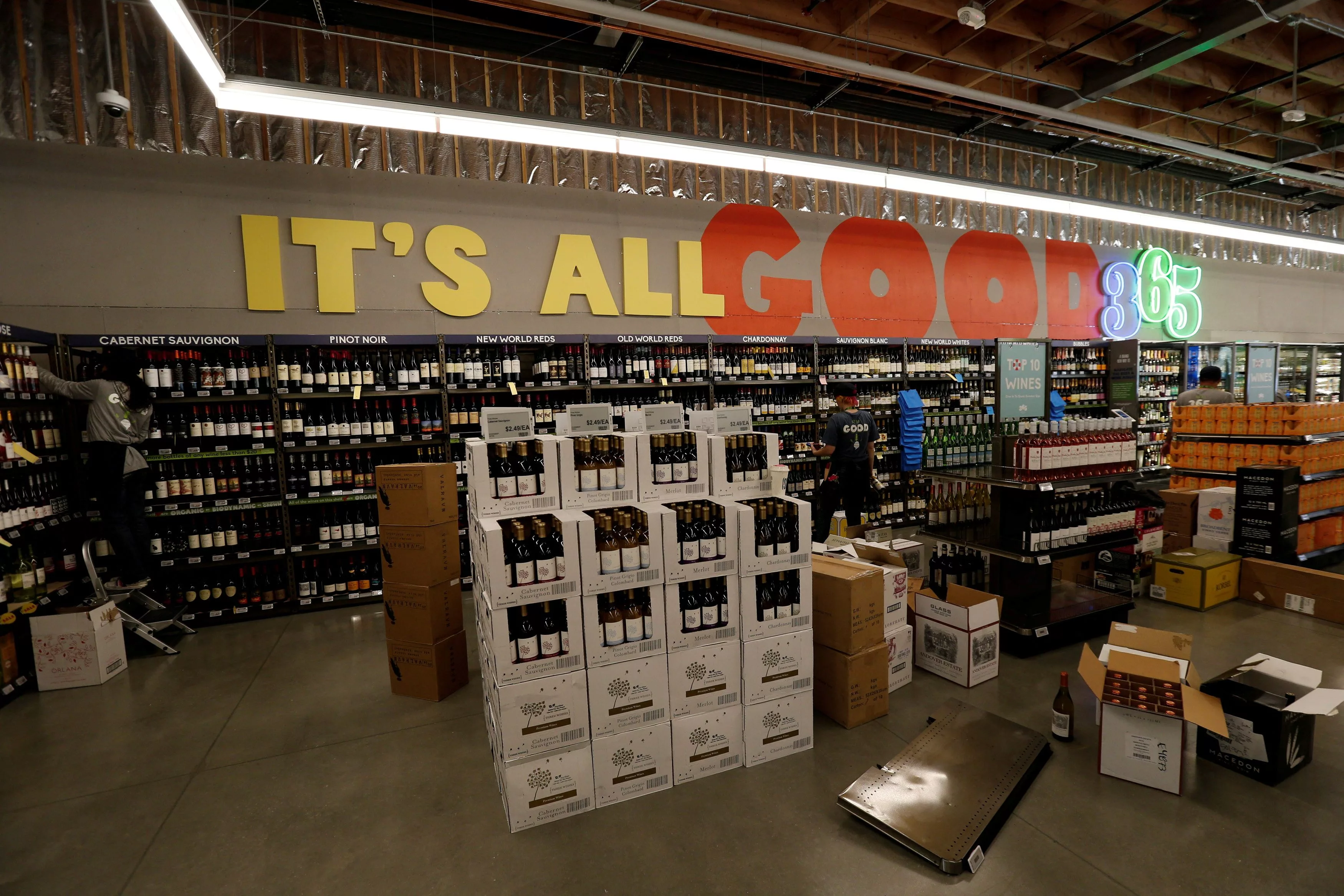 file-photo-employees-arrange-wine-at-a-365-by-whole-foods-market-grocery-store-is-pictured-ahead-of-its-opening-day-in-los-angeles