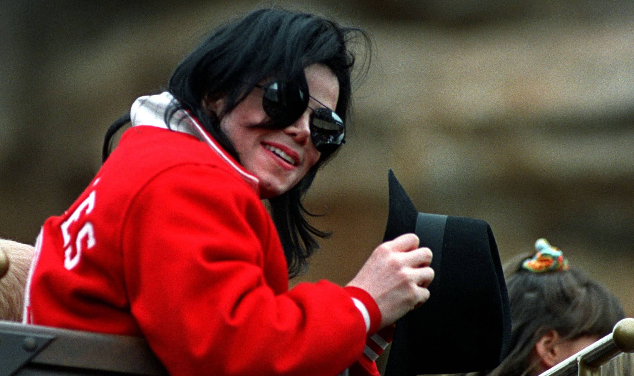 us-popstar-michael-jackson-looks-the-crowd-as-he-sits-in-a-roller-coaster-during-a-visit-of-the-pha