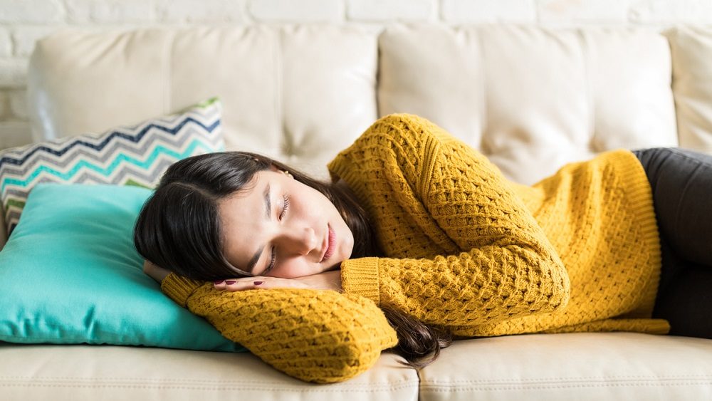woman-sleeping-comfortably-in-living-room